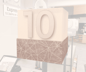 Checkstand light cube from Shop2It Retail's Modern Collection shown in a grocery store décor layout. Checkstand light is acrylic and has a customizable number.