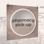 Modern Collection's large department sign with digitally printed text "pharmacy pick-up" centered on a circular overlay.