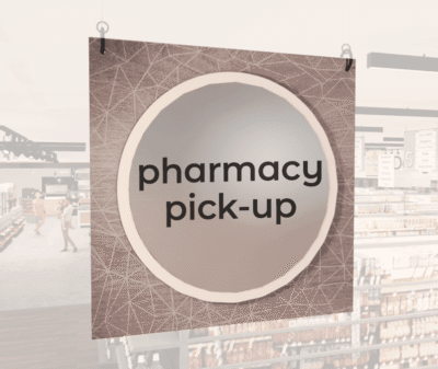 Modern Collection's large department sign with digitally printed text "pharmacy pick-up" centered on a circular overlay.