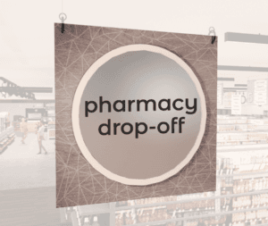 Modern Collection's large department sign with digitally printed text "pharmacy drop-off" centered on a circular overlay.