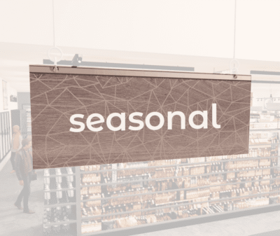 Modern Collection's singled sided small hanging department sign with digitally printed white dimensional text "seasonal."