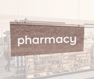 Modern Collection's singled sided small hanging department sign with digitally printed white dimensional text "pharmacy."