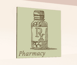 Traditional Collection's wayfinding department sign for the "Pharmacy," that is digitally printed on vinyl-wrapped wood core.