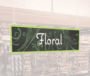 Natural Collection's wayfinding hanging department sign with white text in the center of the signs reads "Floral" on 6 mil PVC