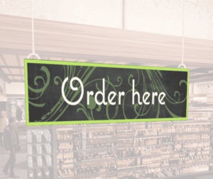 Natural Collection's wayfinding hanging department sign that has "Order Here," digitially printed in white text and on PVC.