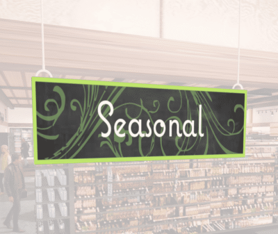 Natural Collection's wayfingding hanging department sign that has "Seasonal," digitially printed in white text and on PVC.