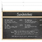 Traditional Collection's Menu Board Chalkboard with overall dimensions 31" tall by 47.5" wide & J-tracks hold menu inserts.