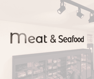 Modern Collection's Meat & Seafood wayfinding large sign wall copy with dimensional wood letters and metal laminate faces.