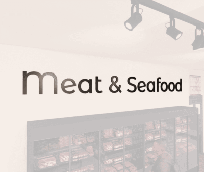 Modern Collection's Meat & Seafood wayfinding large sign wall copy with dimensional wood letters and metal laminate faces.