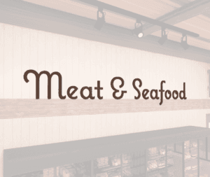 Natural Collection's wall mounted wood letters with a painted finish to be used as a "Meat & Seafood," wayfinding sign.