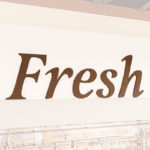 Traditional Collection's wayfinding Produce department sign with the text "Fresh," in dimensional painted wood letters.