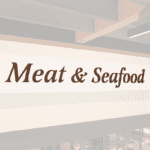 Traditional Collection's wayfinding Meat dept sign with the text "Meat & Seafood," in dimensional painted wood letters.