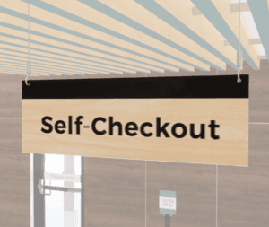 Self-checkout sign with black text and a black stripe on a wood grain background. Double sided from Shop2it Retail.